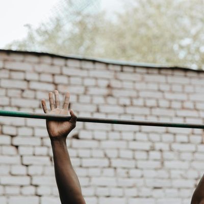 Close-up on a person's hands gripping a pull-up bar.